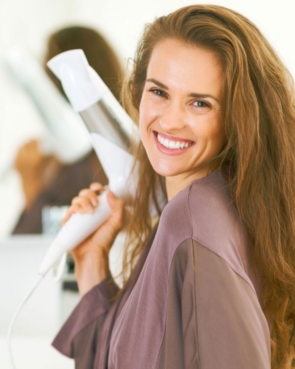 redish-hair-model-smiling-with-hair-dryers
