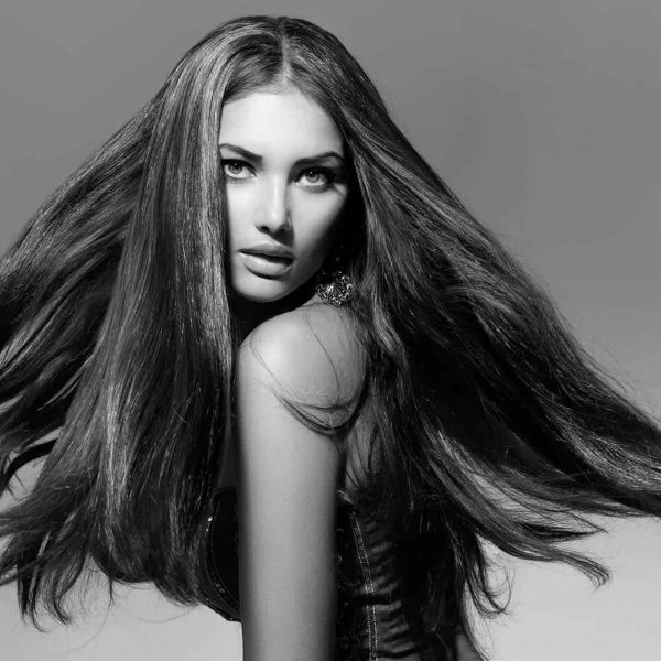 woman-twirlling-long-flowing-hair-in-black-and-white